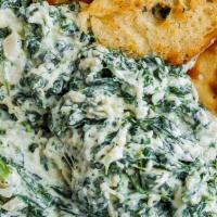 Spinach Dip · Fresh baby spinach mixed with onions, tomatoes and our signature queso dip.