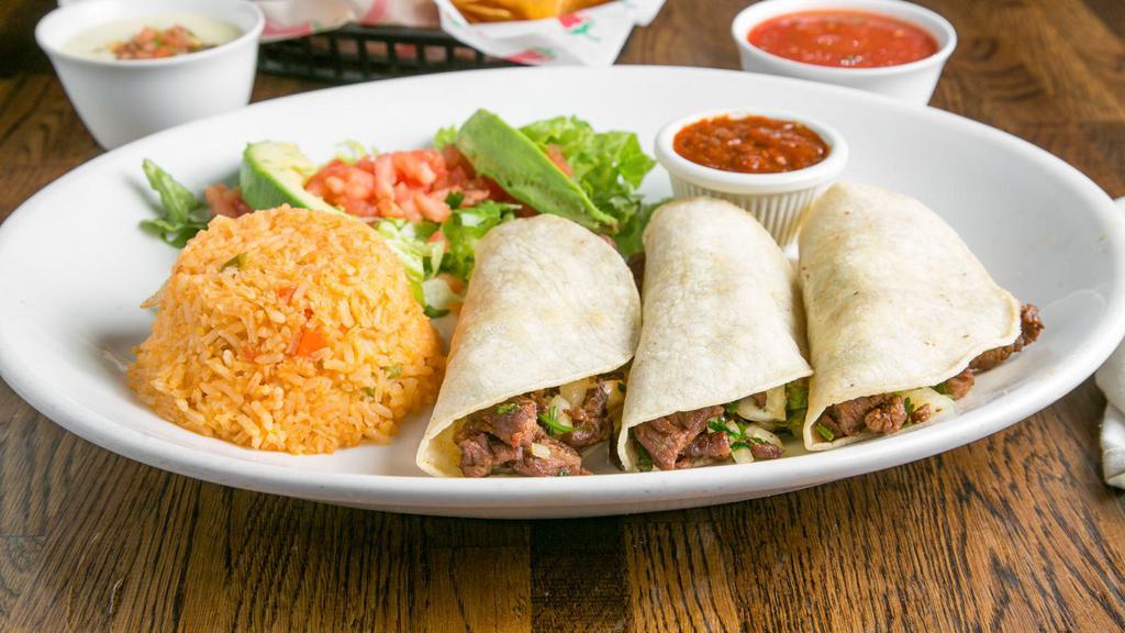 Tacos Mexicanos · Three tacos with your choice of grilled chicken or steak with chopped onion and cilantro served with rice, avocado, lettuce and tomatoes. Served with salsa morita.
