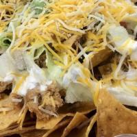 Nachos Deluxe · Our special nacho plate! Chicken, ground beef and beans, topped with lettuce, tomatoes, guac...