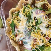 Taco Salad · A crispy flour tortilla shell filled with chicken or ground beef, lettuce, sour cream and sh...