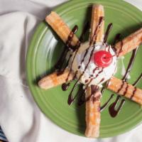 Churros · Four fried strips of dough filled with seasoned apples and sprinkled with cinnamon sugar and...