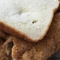 Fish Sandwich · Two lightly breaded pieces of whiting fish fillets, mustard, hot sauce, onions and pickles o...