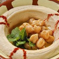 Hummus · Mashed chickpeas with tahini, lemon juice, olive oil, served with pita bread