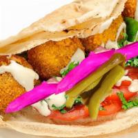 Falafel Wrap · Pita bread filled with falafel, lettuce, tomatoes, onions, turnip pickles and tahini sauce.