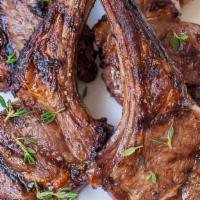 Lamb Chops · 5 pieces of seasoned lamb chops served with spicy potatoes and veggies.