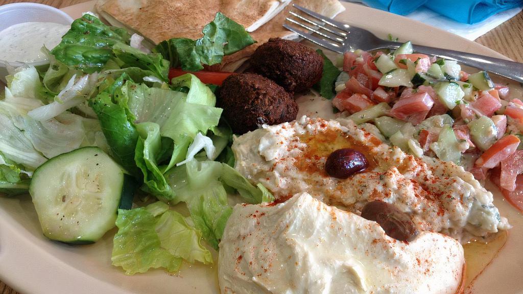 Vegetarian Plate · Hummus, falafel, baba ghannouj, spicy potatoes, and a salad.