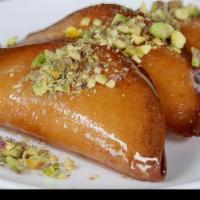 Katayef · Two fried dough stuffed in fresh cheese topped with sweet syrup.