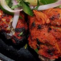 Tandoori Chicken · Tandoori chicken is chicken dish prepared by roasting chicken marinated in yogurt and spices...