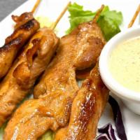 Grilled Chicken Satay · Four pieces. Marinated chicken grilled on a skewer.