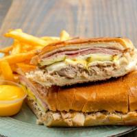 The Cubano - The Cuban Sandwich · Slow-cooked pork tenderloin with smoked ham, pickles, mustard, Mozzarella cheese on real Cub...