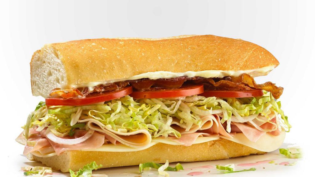 The Factory Club · Our signature classic sub with smoked turkey breast and Black Forest Ham topped with Slab Bacon, lettuce, tomato, red onion, pickles, Mozzarella cheese and Karft mayo.