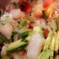 Tostadas De Camarón · Shrimp marinated with lime juice and pico de gallo, topped with avocado and served over a to...