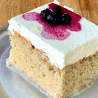 Tres Leches Cake · Fluffy cake soaked in 3 milks, topped w/house maraschino cherries