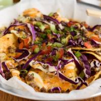 Gogi Nacho · Tortilla chips, drizzled with gogi sauce blend, topped with three types of cheese and beef b...