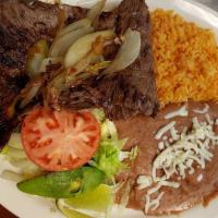 Steak Ala Mexicana · Ribeye steak grilled onions, fresh jalapeños, and tomatoes served with rice, beans and corn ...