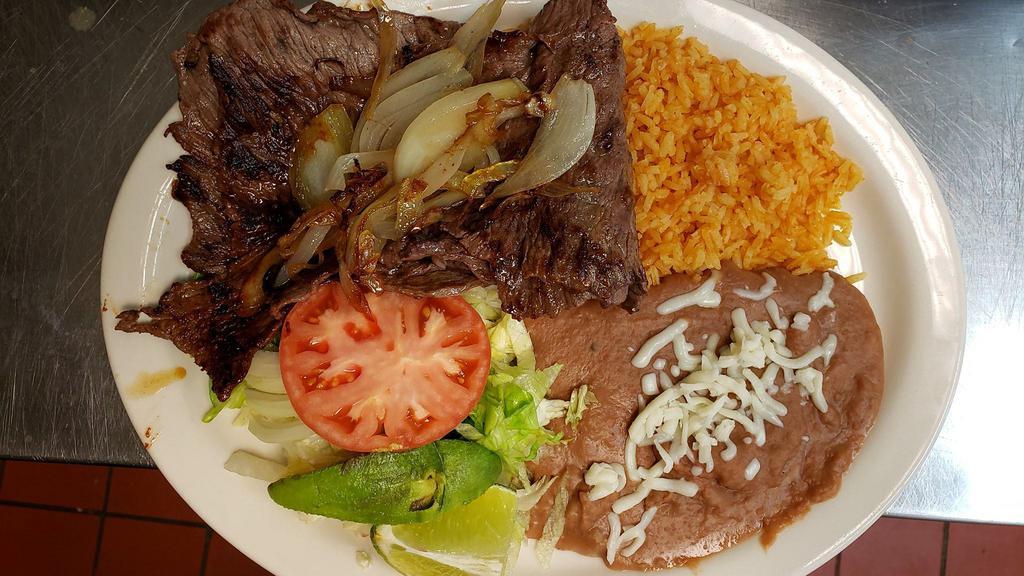Steak Ala Mexicana · Ribeye steak grilled onions, fresh jalapeños, and tomatoes served with rice, beans and corn or flour tortillas.