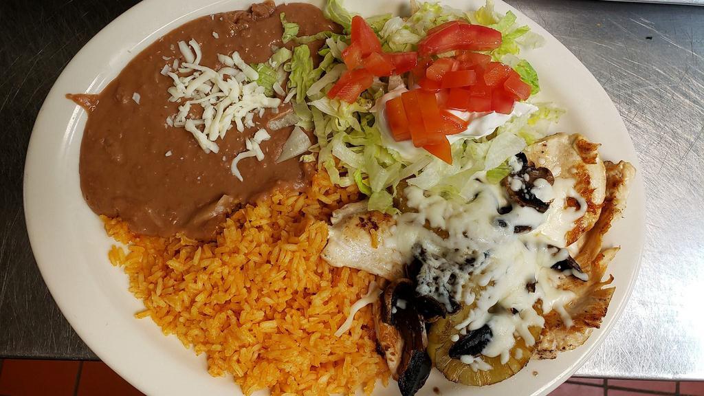 Pollo Hawaiano · Cooked with grilled mushrooms, pineapple cheese, served with rice, beans, and corn or flour tortillas.