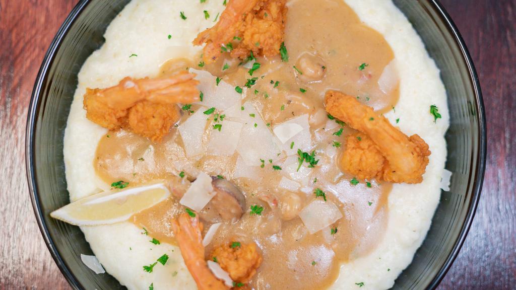 Southern Fried Shrimp N Grits · White truffle cheddar stone ground grits topped with crab crawfish gravy and jumbo fried shrimp.