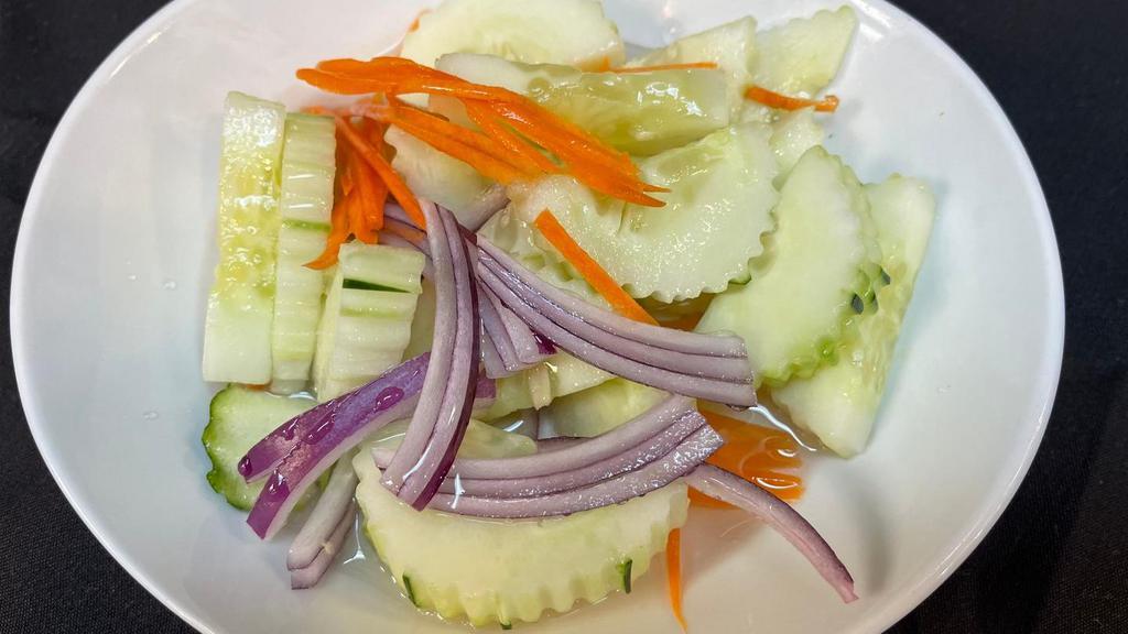 #19. Cucumber Salad · A small plate of fresh cucumber and red onion with a mild and sour sauce.