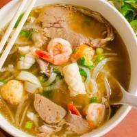 Seafood And Beef Combo Pho · PHỞ ĐẶC BIỆT HẢI SẢN - Topped with shrimp, squid, fish ball, crab meat, rare steak, flank st...