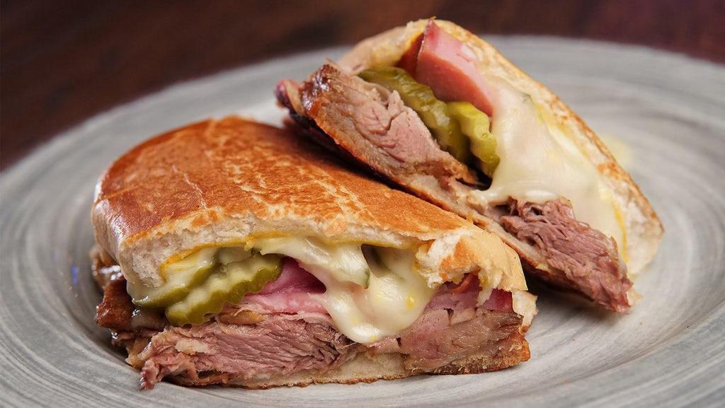 Cuban Sandwich · roasted pulled pork shoulder, ham,. mustard, mayo, swiss cheese & pickles. on a crusty toasted bun