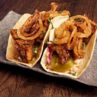 Carolina Pulled Pork Tacos · roasted pulled pork tossed in carolina gold. sauce, on top of coleslaw with thin fried. onio...
