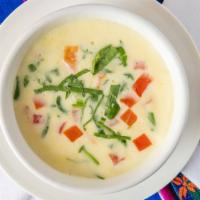 Queso Blanco · White cheese dip with diced tomatoes and fresh spinach.