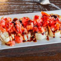Bruschetta · Fresh tomatoes, thyme and rosemary on a French baguette with balsamic drizzle.