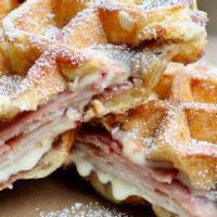The Cristo · Waffle sandwich with smoked turkey, blackforest ham, melted white cheddar, and berry jam.