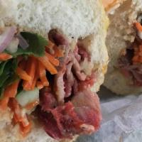 Roasted Sweet Pork Banh Mi · Dressed with butter aioli, cucumber, pickled carrots, cilantro, jalapeños, onions, and soy s...