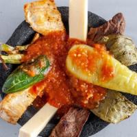 Molcajete · Steak, Chicken Breast, Chorizo, Shrimp. Peppers, Cheese Dip Special Sauce, Onions. Served wi...