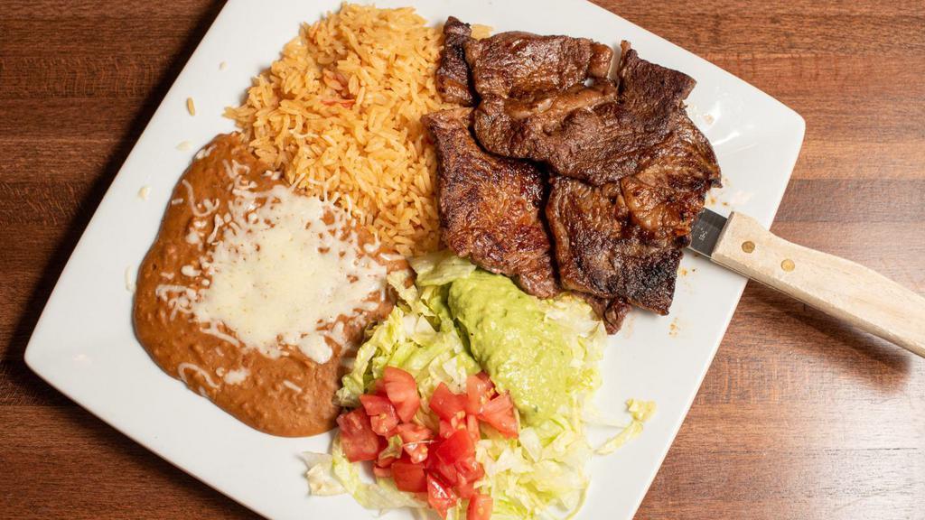 Carne Asada · Tender, seasoned beef, served with rice, beans, guacamole salad, and three tortillas.
