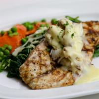 Wood Grilled Redfish · Cajun seasoning with lemon butter sauce and crabmeat, paired with seasonal vegetables.