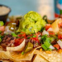 Nachos · Build your own nachos. Queso comes on the side.