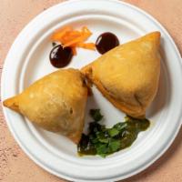 Samosa (V) · Triangular pastry filled with spiced hash potatoes & green peas.