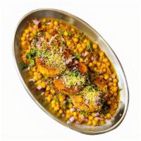 Ragda Patties (V) · Potato patty topped with curried chickpeas, our tangy tamarind sauce, and finely chopped oni...