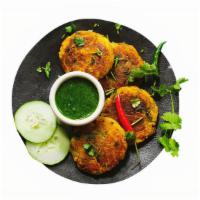 Aloo Tikki (V) · Potato fritters blended with Indian spices & deep fried.