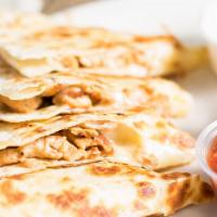 Quesadilla · Stuffed with grilled chicken or steak, served with sour cream and salsa.