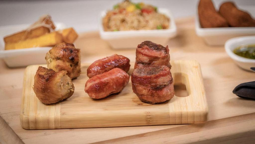 Three Meat Combo · 2 pieces of chicken (aji chicken thigh or beer drumsticks), 2 pieces of filet wrapped in bacon, and 2 pieces of Brazilian sausage.