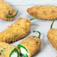 Jalapeño Poppers (6) · Juicy jalapeño poppers breaded and filled with cheese and fried to golden perfection.