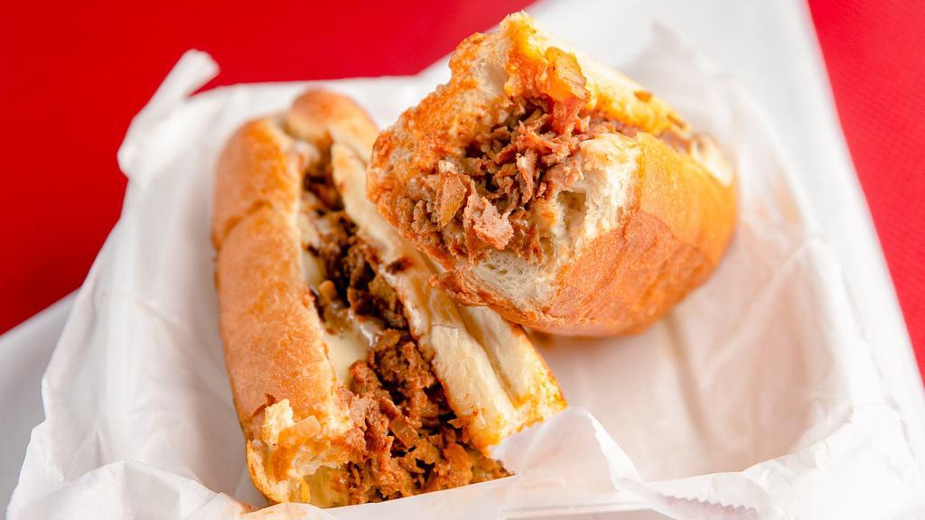 Cheesesteak (8 Oz) · A cheesesteak is a sandwich made from thinly sliced pieces of beefsteak and melted cheese in a hoagie roll.