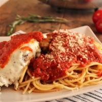 Chicken Parmigiana · Breaded chicken breast, topped with marinara sauce and mozzarella cheese. Served with a sala...