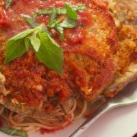 Eggplant Parmigiana · Breaded eggplant, topped with marinara sauce and cheese.