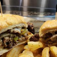 The Philly · Grilled steak or chicken covered in mushrooms, peppers, onions, and provolone. Served in a t...