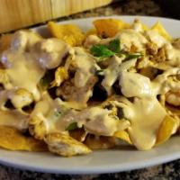 Fajita Nachos · Tortilla chips piled high with onions, bell peppers, mushrooms, and your choice of fajita ch...