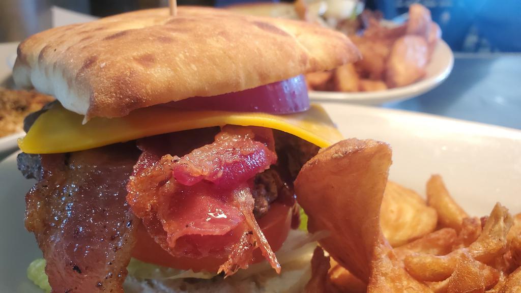 Bbq Bacon Cheddar Burger · Hand-pattied burger topped wit BBQ sauce, sharp cheddar, bacon, lettuce, tomato, pickle & red onion on a bistro bun