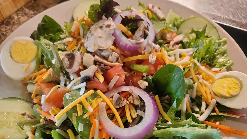 Mom'S Garden Salad · Mix of fresh greens topped with tomatoes, sliced cucumber, mushrooms, red onion, carrots, shredded cheese and a boiled egg with your choice of dressing.