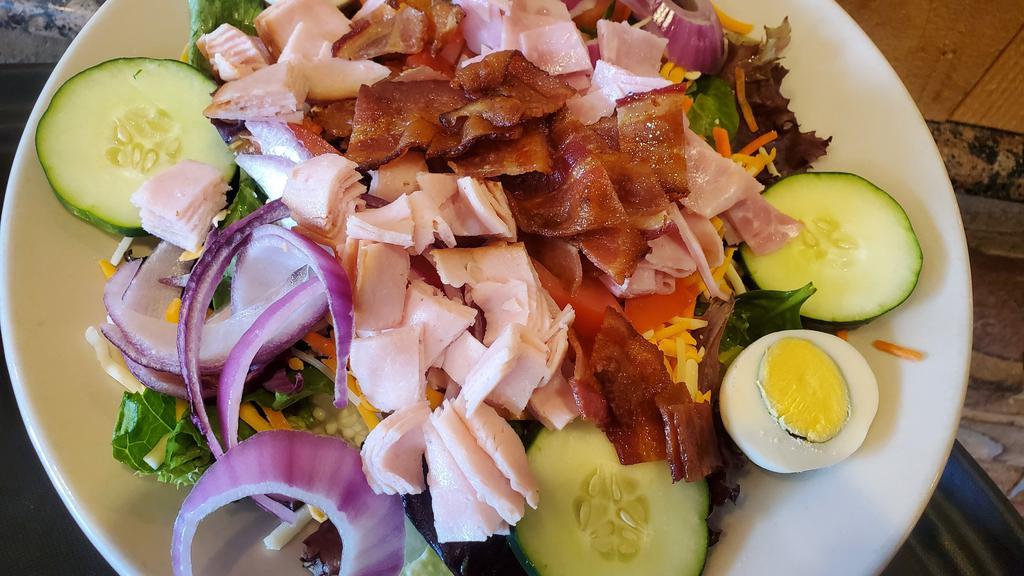 Chef Salad · Mixed greens topped with diced smoked turkey breast, smoked ham, crisp bacon, shredded carrots, cheddar-jack cheese, diced tomato, sliced cucumber, red onion & boiled egg