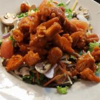 Buffalo Chicken Salad · Crispy buffalo chicken on a bed of mixed greens with shredded carrots, sliced red onion, dic...