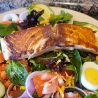 Grilled Salmon Salad · Grilled salmon filet with garlic herb served on a bed of mixed greens with shredded carrots,...